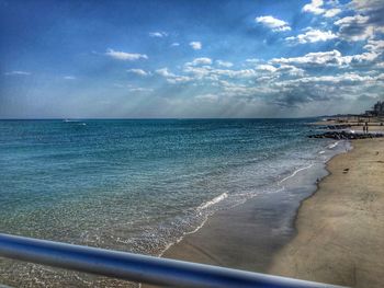 Scenic view of sea against cloudy sky