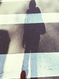 Shadow of people on road