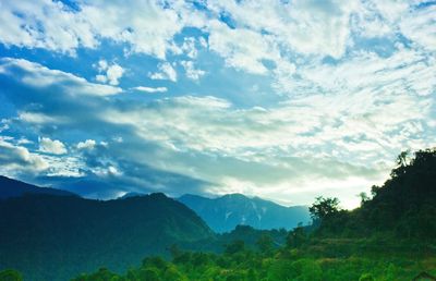 Scenic view of mountains against cloudy sky