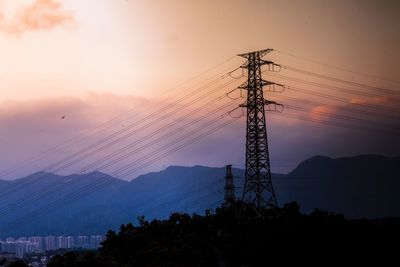 Low angle view of electricity pylon against sky