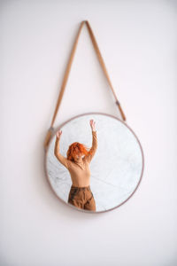 High angle view of woman with tattoo on white background