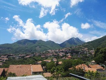 Townscape by mountains against sky