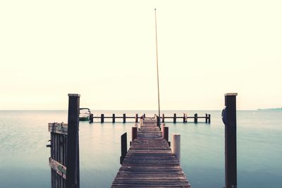 Pier on sea against clear sky