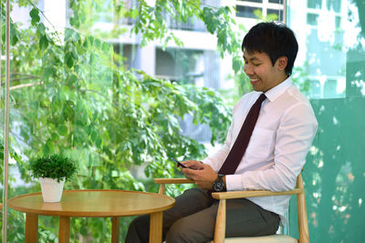 Businessman using digital tablet at table in office