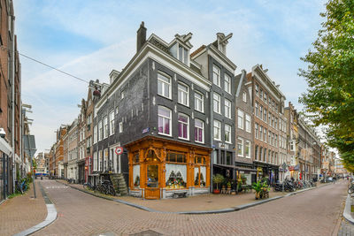 Street amidst buildings against sky