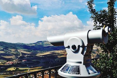 Close-up of coin-operated binoculars against sky