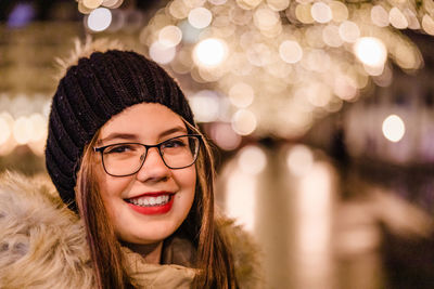 Portrait of smiling woman in hat during winter