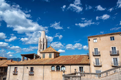 Low angle view of buildings against blue sky