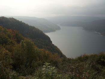 Scenic view of sea and mountains against sky