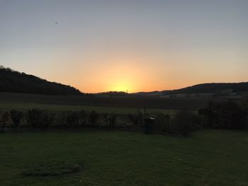 Scenic view of field against sky during sunset