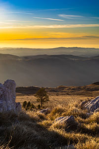 Scenic view of landscape against sky during sunset