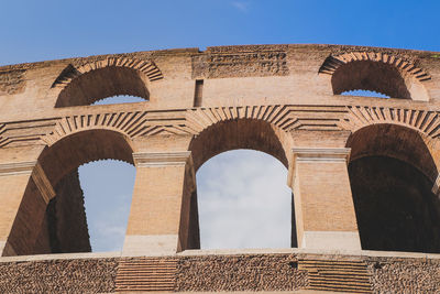 Low angle view of arched structure against sky