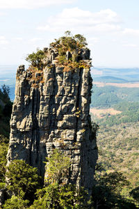 Built structure on rock against sky