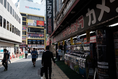 People walking on street market in city