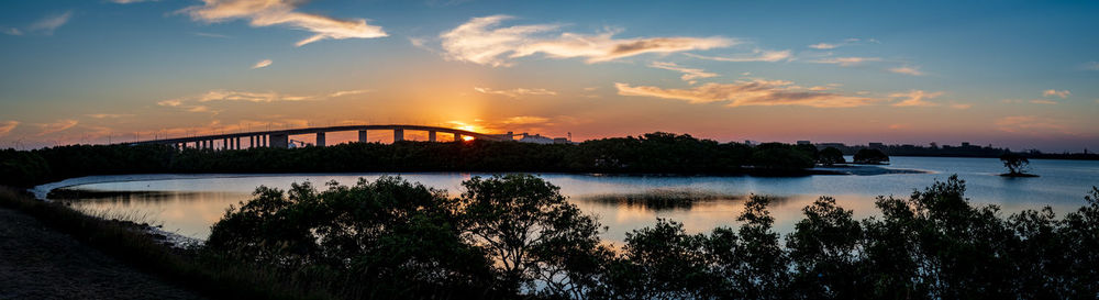 Bridge over river against sky during sunset