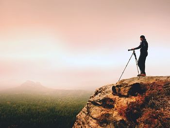 Man looking at mountain against sky