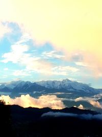 Scenic view of mountains against cloudy sky