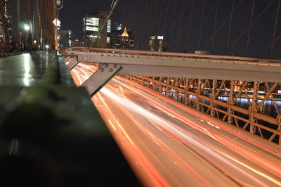 Light trails on bridge in city at night