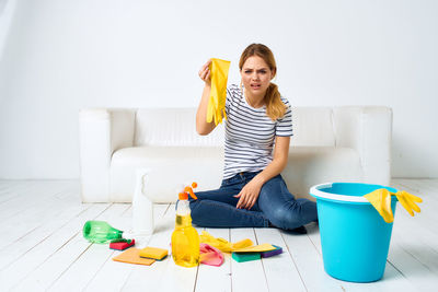 Portrait of smiling young woman painting on table