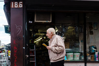 Full length of man working on mobile phone