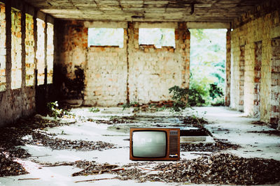 Old television set in abandoned house