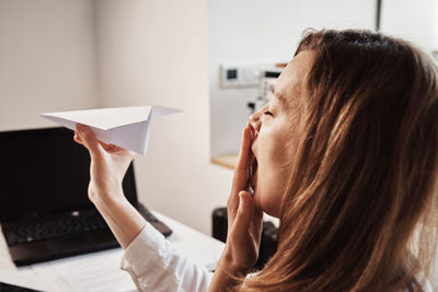 Woman procrastinate at workplace. freelancer on remote work at home office. unmotivated tired woman