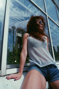 Rear view of woman sitting by window