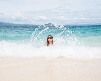 Portrait of woman in sea against sky