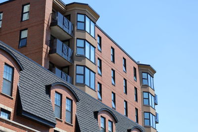 Low angle view of building against clear blue sky