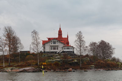 Building by river against sky