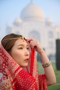 Portrait of young woman looking away outdoors