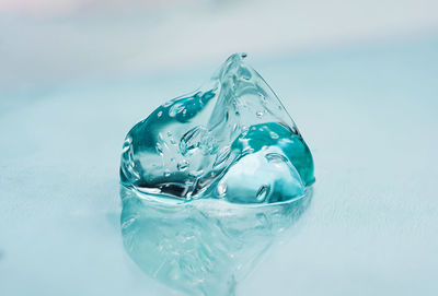 Cosmetic transparent gel with hyaluronic acid with bubbles on a blue background