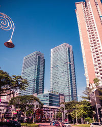 Low angle view of buildings against clear blue sky