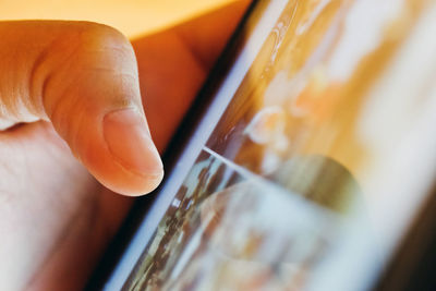 Close-up of hand using digital tablet