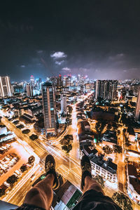 High angle view of city lit up at night