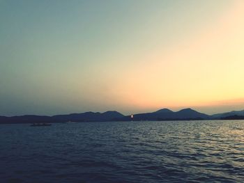 Scenic view of sea against clear sky during sunset