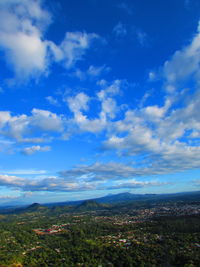 Scenic view of mountains against cloudy sky