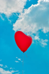 Low angle view of balloons against blue sky