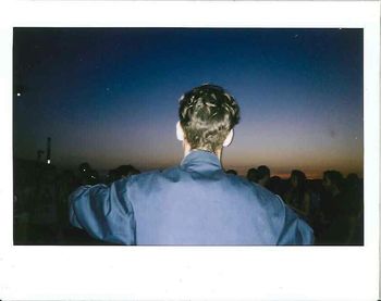 Rear view of man against blue sky
