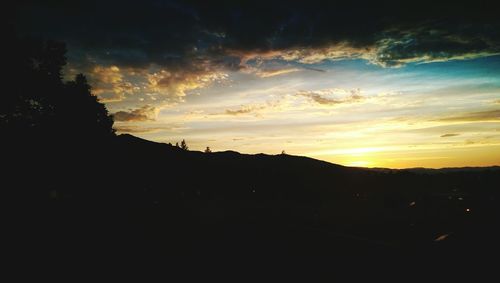 Scenic view of silhouette mountains against sky at sunset