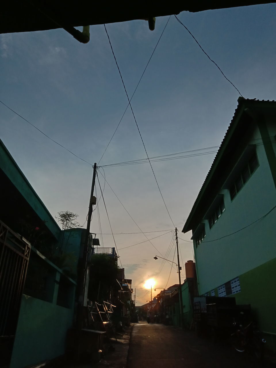 LOW ANGLE VIEW OF CITY STREET AT SUNSET