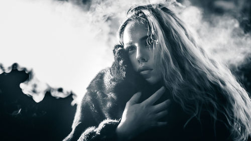 Close-up of young woman against sky