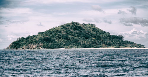 Scenic view of sea and mountains against sky