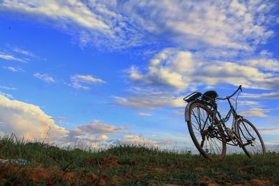 Bicycle on field against sky