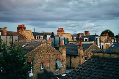 Houses in city against sky