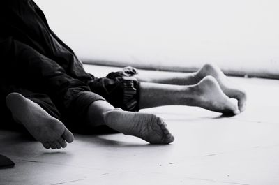 Midsection of woman resting on floor