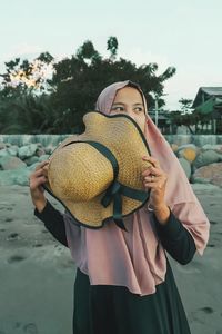 Midsection of woman wearing hat standing in winter