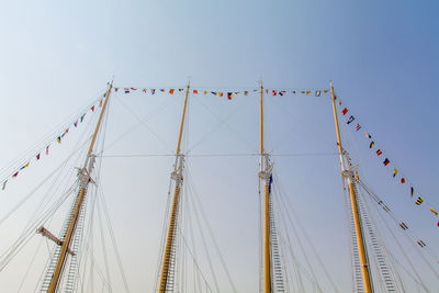 Flags hanging on masts against cleat sky