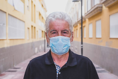 Portrait of man wearing mask standing outdoors