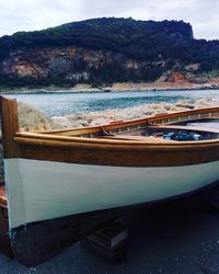 Boats moored on sea against sky